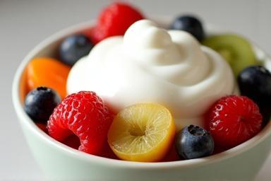 A vibrant bowl of fruit salad topped with yoghurt